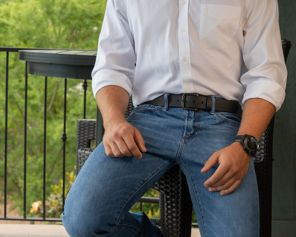 The Specialist Black Leather Belt on a model wearing blue jeans- Black Carbon Fiber Buckle with Black Full Grain Leather Strap